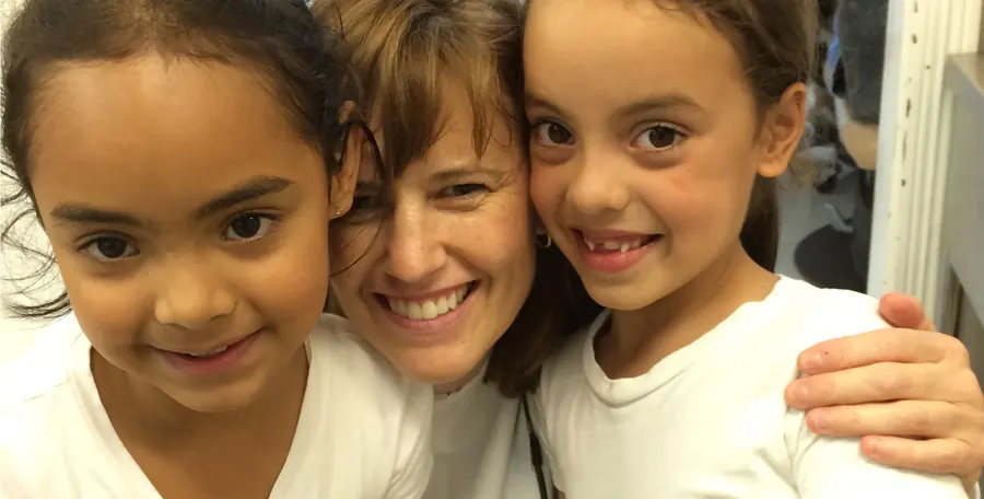 Dr. Kate Schacherl with two young girls on a Main Street Dentists volunteer trip to Honduras.